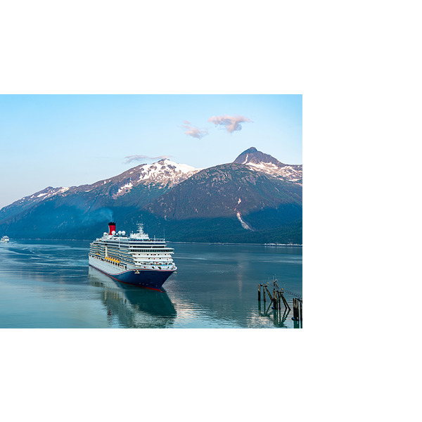 Kreuzfahrtschiff fährt durch einen ruhigen Fjord mit schneebedeckten Bergen im Hintergrund.